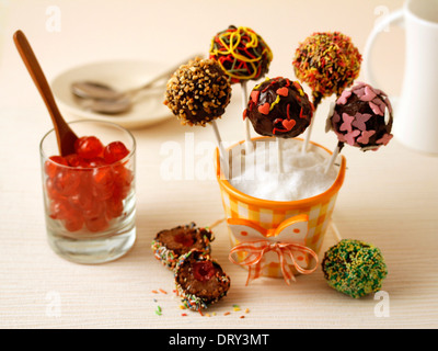 Chocolate cake pops with cherries. Recipe available. Stock Photo