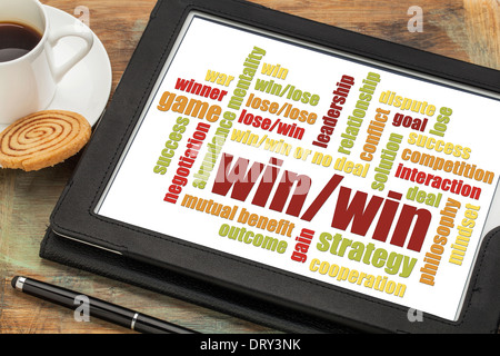 win-win strategy word cloud on a digital tablet with a cup of coffee Stock Photo