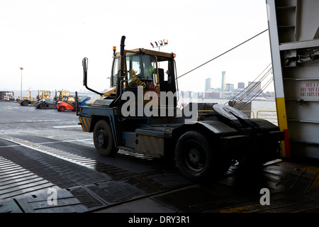 crew member driving freight trailer tug for loading cargo on irish sea ferry birkenhead merseyside uk Stock Photo