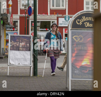 Blind young girl using a cane to get around the city, Reykjavik, Iceland Stock Photo