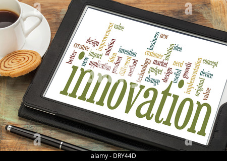 innovation concept - word cloud on a digital tablet with a cup of coffee Stock Photo