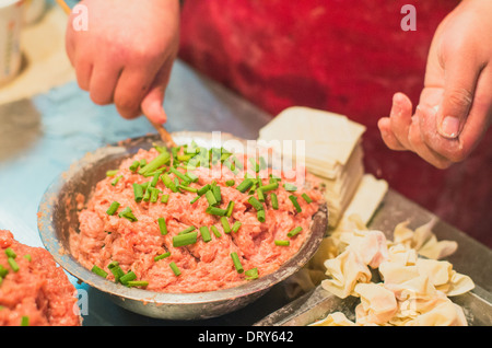 making of wonton, a kind of chinese dumplings. Photo is taken at Hubu lane snack street in Wuhan, China.  Stock Photo