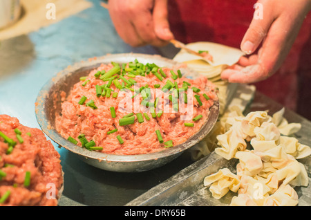 making of wonton, a kind of chinese dumplings. Photo is taken at Hubu lane snack street in Wuhan, China.  Stock Photo