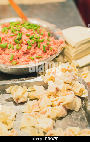 making of wonton, a kind of chinese dumplings. Photo is taken at Hubu lane snack street in Wuhan, China.  Stock Photo