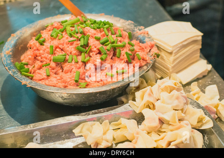 making of wonton, a kind of chinese dumplings. Photo is taken at Hubu lane snack street in Wuhan, China.  Stock Photo