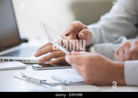 Men using digital tablet, cropped Stock Photo