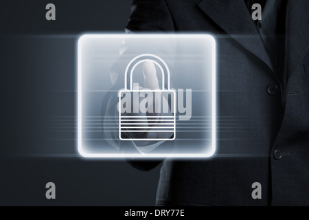 Businessman pressing lock button on futuristic touchscreen Stock Photo