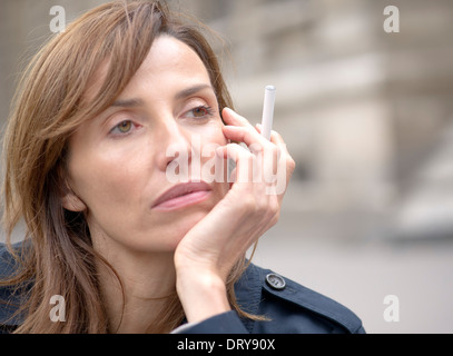 Woman smoking electronic cigarette outdoors Stock Photo