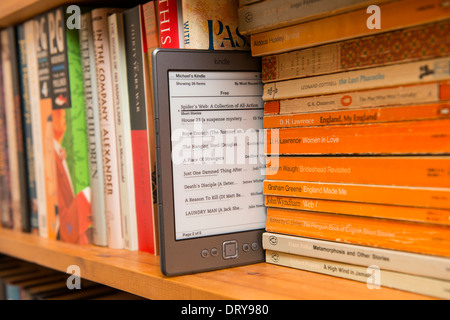 An  kindle in a bookshelf Stock Photo - Alamy