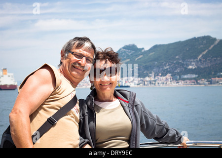 Happy middle aged couple enjoying summer boat trip. Stock Photo