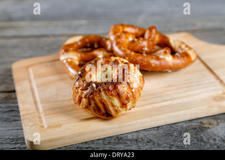 Soft newly-baked rolls on an old kitchen table Stock Photo