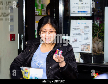 LONDON, UK, 2ND FEB 2014. Lady handing out Snap bangers to people during Chinese New Year in London Stock Photo