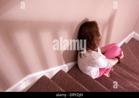 Woman sitting on the stairs back view. Stock Photo
