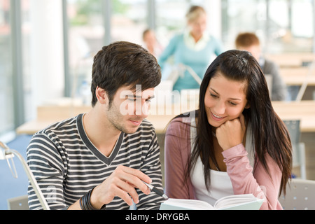 Two students read book in classroom Stock Photo