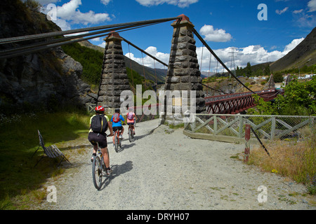 Mountain bikers crossing Historic Kawarau Bridge (Bungy Bridge) on Arrow River Bridges Ride, Otago, South Island, New Zealand Stock Photo