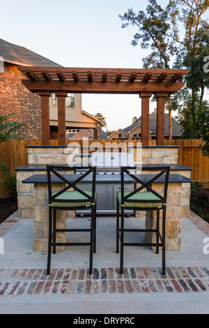 Backyard patio and grill at suburban middle-class home Stock Photo