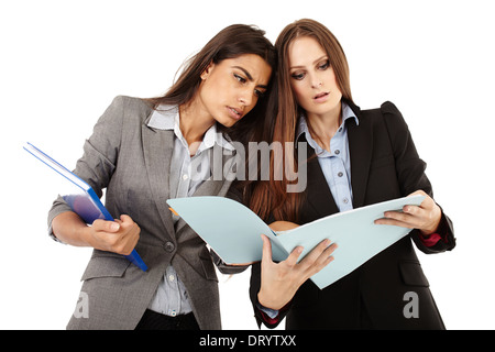 Two successful businesswomen dicussing and looking to documents isolated on white Stock Photo