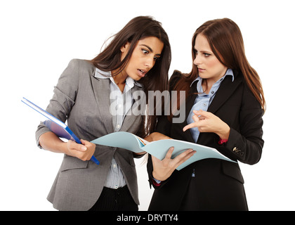 Two successful businesswomen discussing and looking to documents isolated on white Stock Photo