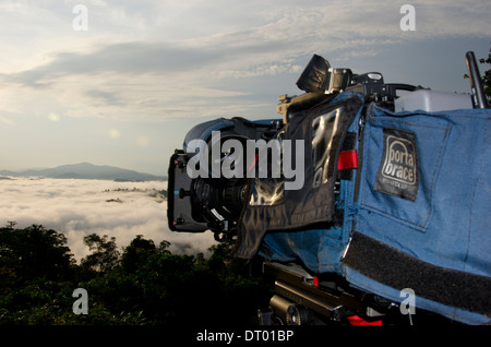 Video camera filming sunrise with low clouds covering valley, Danum Valley, Sabah, East Malaysia, Borneo Stock Photo
