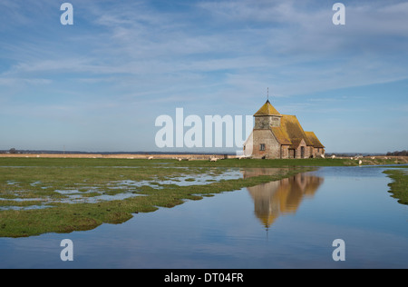 The Church of St Thomas a Becket in Fairfield, Kent; reflected in the surrounding flooded fields and marsh land. Stock Photo