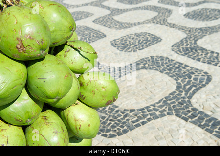 Bunch of fresh green Brazilian coco verde coconuts hanging at Ipanema Beach boardwalk Rio de Janeiro Brazil Stock Photo