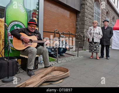 Street scene with man playing guitar, Reykjavik, Iceland Stock Photo