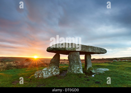 A brief moment of sunlight streaking across the dawn sky at Lanyon Quoit Stock Photo