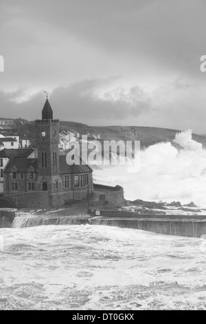 Giant waves crash against Porthleven causing damage to buildings and sinking at least four boats in the harbor. Cornwall 5/2/14 Stock Photo