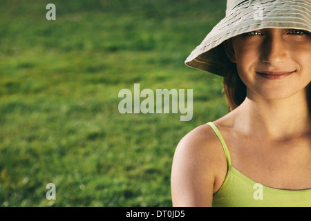 Seattle Washington USA smiling nine year old girl sitting on the grass Stock Photo