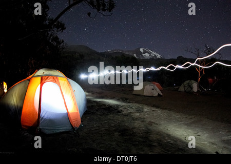 headlamp light trails with tents at night at the Machame camp on Mount Kilimanjaro Stock Photo