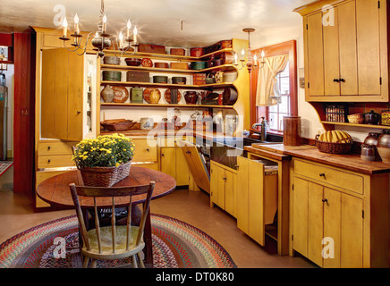 An interior vies of the kitchen in an authentic primitive colonial reproduction home. Stock Photo