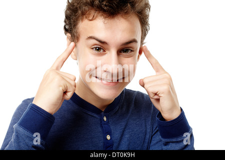 Closeup of smart teenager pointing his head with fingers having a brilliant idea, isolated over white background Stock Photo