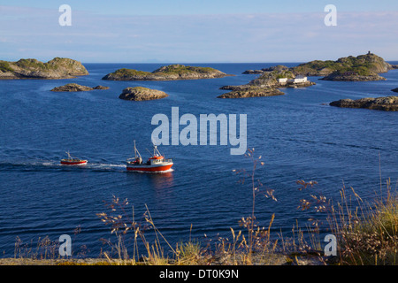 Fishing boats returning to port in Henningsvaer on Lofoten Islands, Norway Stock Photo