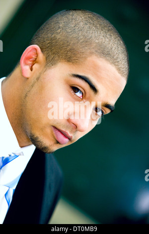 Young urban professional in early 20's wearing a dark suit. Stock Photo