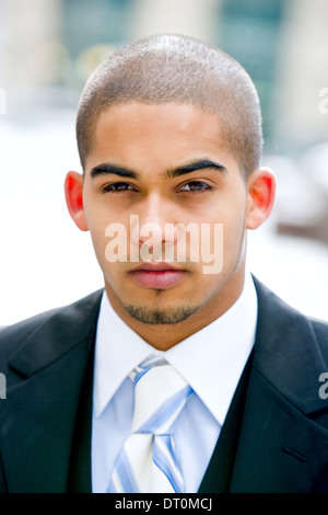 Young urban professional in early 20's wearing a dark suit. Stock Photo