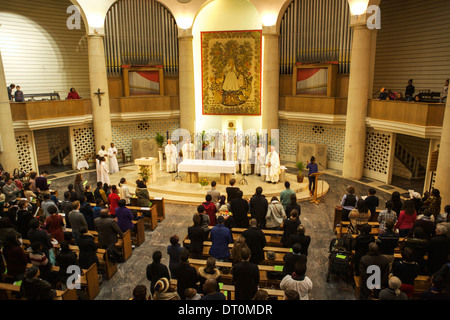 Religious service with priests and congregation in a church in central London: The Roman Catholic Church of Notre Dame De France Stock Photo