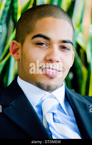 Young urban professional in early 20's wearing a dark suit. Stock Photo