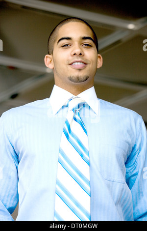 Young urban professional in early 20's wearing blue shirt and tie. Stock Photo