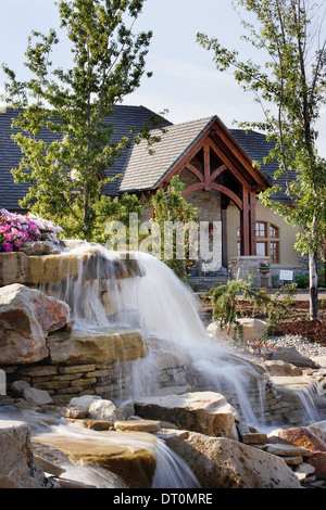 A man made water fall in the landscaping at an upscale residence. Stock Photo