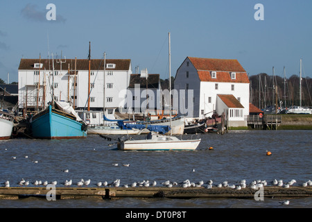 Woodbridge Tide Mill with boats and gulls resting on pontoon Stock Photo