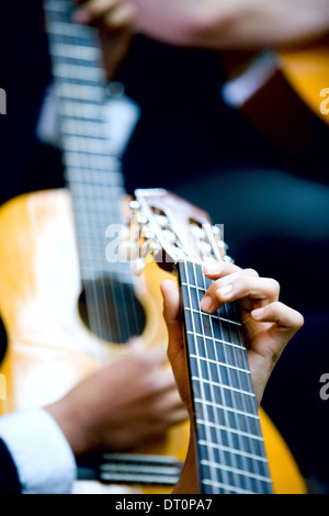 Close up of hands playing guitars Stock Photo