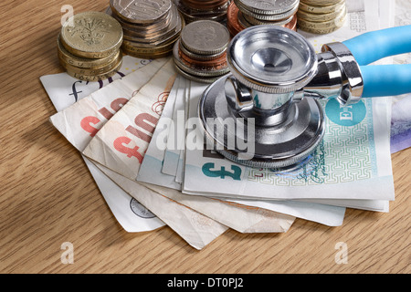 Stethoscope monitoring a pile of money Stock Photo