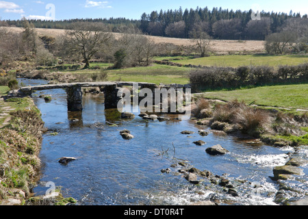 Historic clapper bridge, an ancient form of bridge found on the moor at Postbridge, Dartmoor National Park, Devon, England. Stock Photo