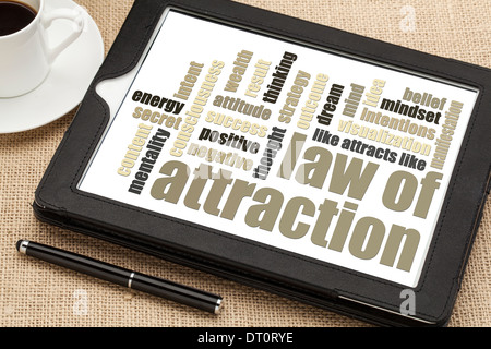 law of attraction word cloud on a digital tablet with cup of coffee Stock Photo