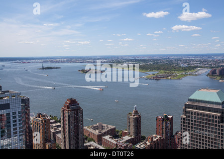 View of the Statue of Liberty and Ellis Island in the Hudson River looking west from 4 World Trade Center Stock Photo