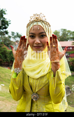 A newlywed Malay couple dressed in traditional Malacca royalty clothing. Stock Photo