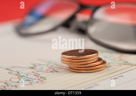 Pile of pennies on graph. Stock Photo