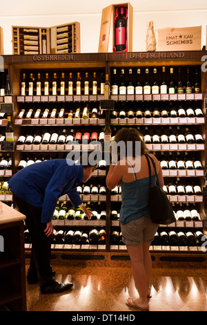 Customer in Wine Department at Dallmayr food store in Munich, Bavaria, Germany Stock Photo