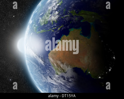 Sunset over Australia region on planet Earth viewed from space with Sun and stars in the background. Elements of this image furnished by NASA. Stock Photo