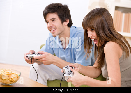 Student - happy teenagers playing video game Stock Photo